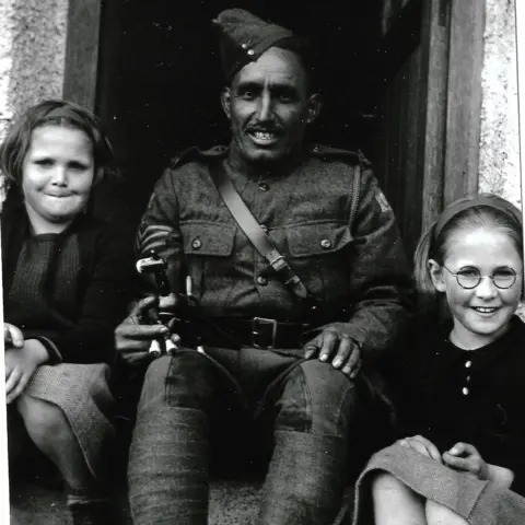 J L Legge Force K6 soldier and local children