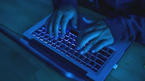 Generic image of anonymous person using a laptop keyboard