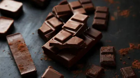 Chunks of broken chocolate on a piece of slate