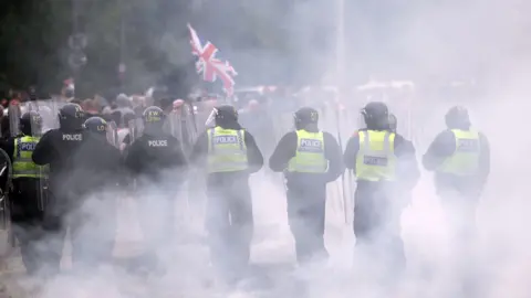 Getty Images UK police officers dealing with a riot