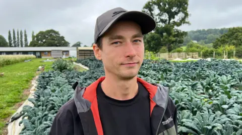 Shem Bullen stood among green crops