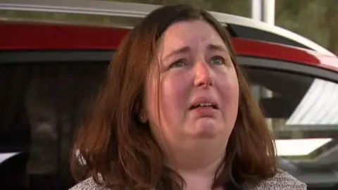 A close up of Erin Patterson crying