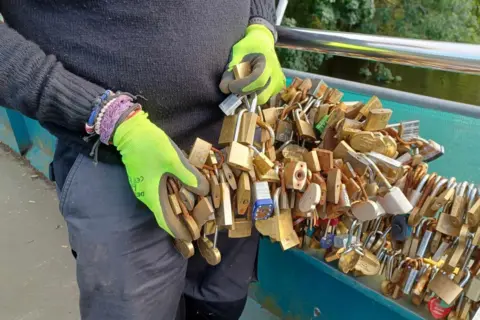 Save the Love Locks at Bakewell Mike Hall holds some of the love locks