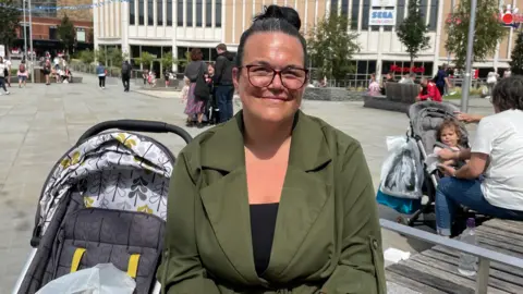 Tom MacDougall/BBC Carly Hambleton sat in Barnsley's town centre.