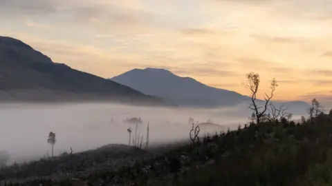 Colin Ferrington Two mountain peaks with a misty valley