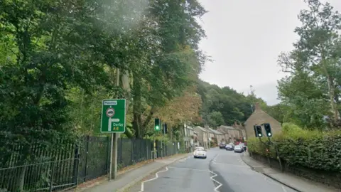 Google Road with trees in the background on the left