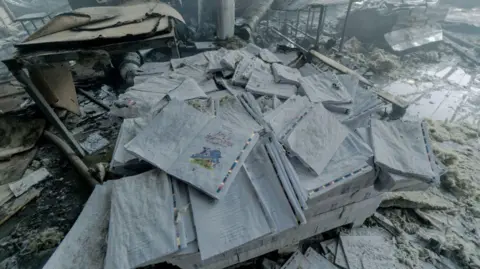 Getty Images Rescuers respond at the site of a Russian missile strike on the Faktor Druk printing plant on 23 May 2024 in Kharkiv