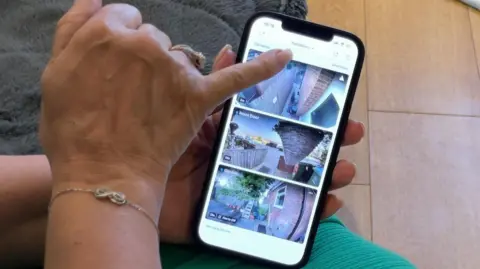 A woman pointing to her phone, which shows screenshots of video doorbell footage