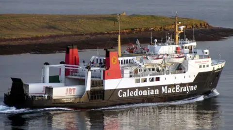 CalMac A black and white ship with red funnels sailing away from the camera with a headland in the background