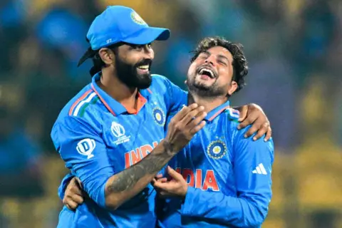 AFP India's Kuldeep Yadav (R) celebrates with Ravindra Jadeja after taking the wicket of Netherlands' Logan van Beek during the 2023 ICC Men's Cricket World Cup one-day international (ODI) match between India and Netherlands at the M. Chinnaswamy Stadium in Bengaluru on November 12, 2023