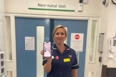 University Hospitals Dorset nurse holding phone
