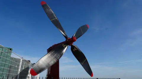 Four blade hovercraft propeller it is painted black with red tips