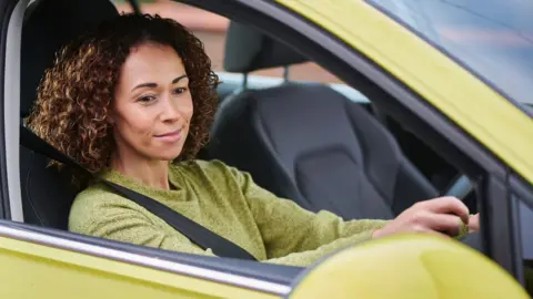 Female driver checking mirror