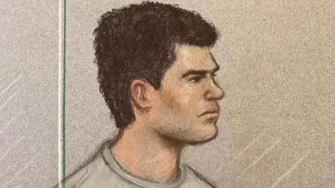 A court artist drawing of Jake Cummings:  The image shows a man with short dark hair, wearing a grey, round-neck top and sitting on a green chair.
