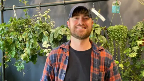 Alex Pope/BBC Tony Le-Britton standing in his shop