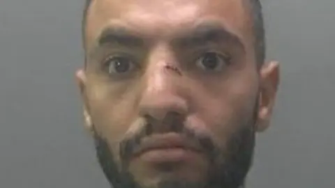 A custody photo of a man with a cut on his nose