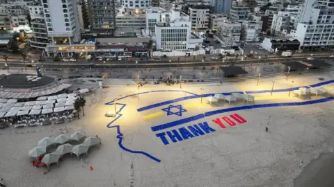 Reuters A giant sign created on a Tel Aviv beach reads 