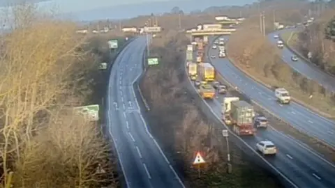 The A14 is busy with cars travelling away from the camera. The road to the left leads towards the Copdock Interchange and is quiet as the road beyond it has been closed.