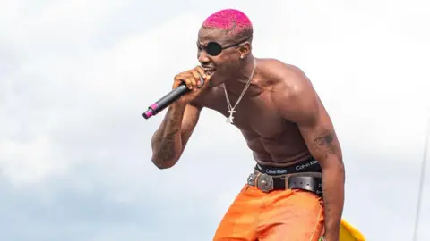 Getty Images Ruger performs onstage during time  2 of the Afro Nation Detroit 2024 Festival astatine  Bedrock's Douglass Site connected  August 18, 2024 successful  Detroit