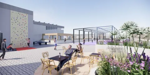 Urban Splash A man sits on a chair in a rooftop bar, alongside a climbing wall