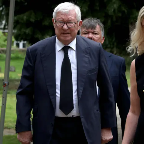 Manchester Evening News Sir Alex Ferguson joins other mourners outside the church