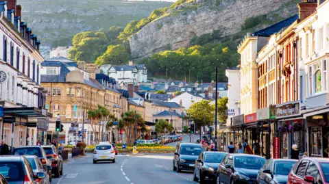 A street in Llandudno, with cars along the street