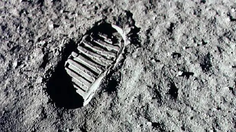 NASA/Newsmakers Neil Armstrong's human footprint on the surface of the moon in black and white 