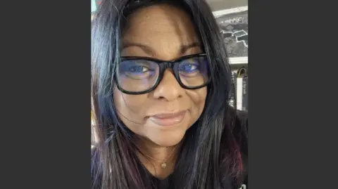 Tabitha Mudaliar A woman with dark hair and glasses