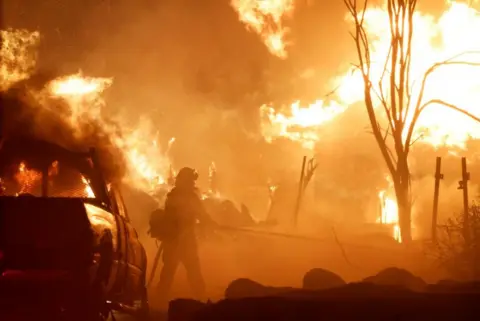 Reuters Firefighters work as Park Fire burns near Chico, California