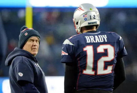 Getty Images Bill Belichick standing on the sidelines next to quarterback Tom Brady with the New England Patriots in 2019