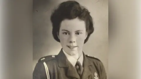 Supplied An old black and white picture of a woman with thick dark hair and wearing a military uniform.