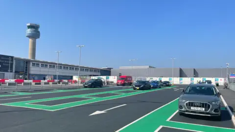 East Midlands Airport A car park at the airport with the air traffic control tower in the background 