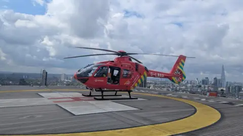 BBC The air ambulance sits on the air pad