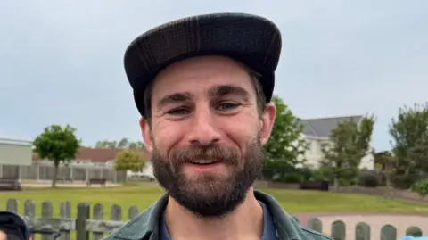 Steven De Ste Croix is pictured in St Ouen's village. Steven is wearing a hat, has brown hair and a beard 