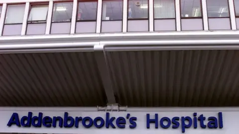 PA Media A sign saying "Addenbrooke's Hospital" at the entrance to the site, in big blue individual letters.