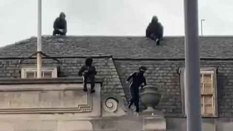 Danni MacRae Group of boys dressed in black spotted on the roof of the former Debenhams store in Nottingham city centre.