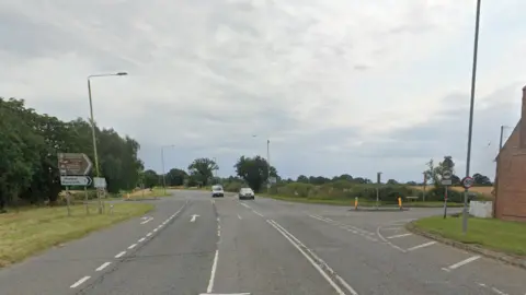 A crossroads with cars on it 