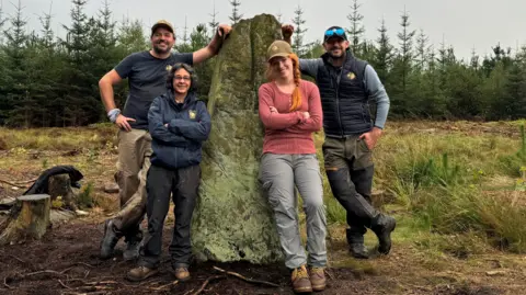 Time Team Time team stood leaning on Farley Moor standing stone