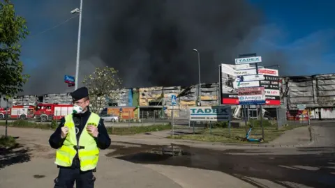 Black smoke seen in the sky above the burning Marywilska 44 shopping center in Warsaw