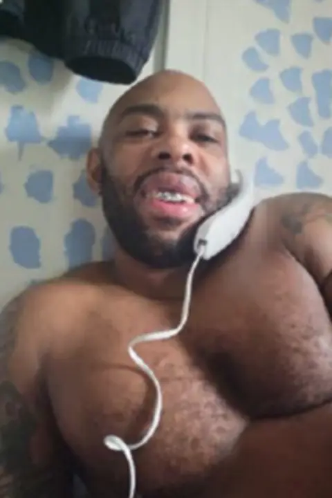 Nottinghamshire Police Yeboah is topless and on a traditional phone with a cord