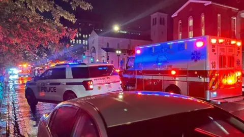A police car and ambulance on the street