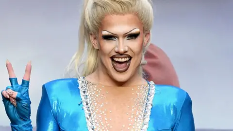 Getty Images Elektra Fence, a drag artist, in an electric blue dress and heavy makeup