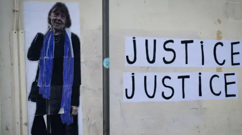 MIGUEL MEDINA/AFP A mural in Avignon shows a picture of Gisèle Pelicot and reads "justice, justice"