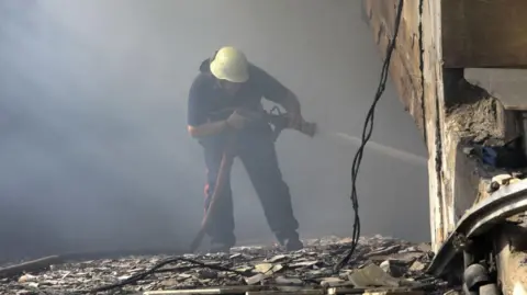 AFP A firefighter works at the site of an overnight Israeli air strike in Beirut's southern suburb of Shayyah on October 2, 2024. 