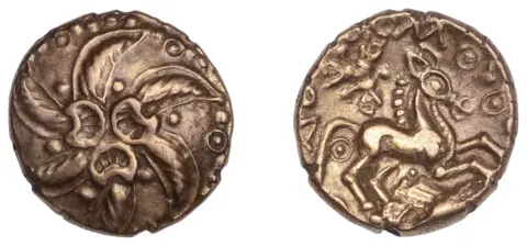 Noonans Two views of an Iron Age gold coin. On the left the face shows a six-armed wreath spiral, three crescents at centre. On the right, the face shows a horse rearing up on its hind legs. 