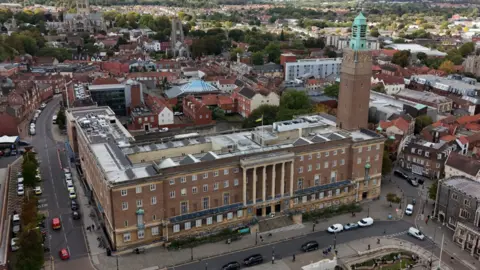 City Hall in Norwich, as seen from a drone, showing St Peter's Street, Bethel Street, Guildhall, St John's Cathedral, St Giles church and other surrounding buildings, looking west towards Earlham Road and Dereham Road