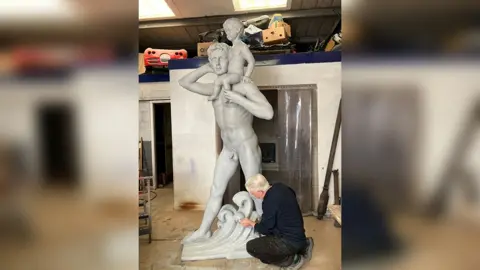 Will Hennessy Man working on a statue