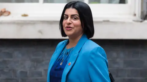 Getty Images  Shabana Mahmood, with dark hair and wearing a blue suit, looks to her left towards the camera as she walks along Downing Street 