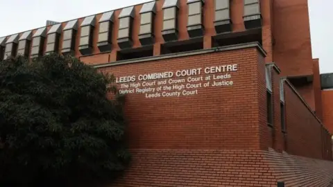 General view of Leeds Crown Court, a red-brick building bearing the name of the court.
