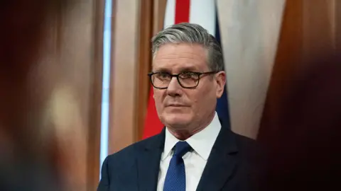 Sir Keir Starmer looking reflective, as he prepares to address a Downing Street news conference